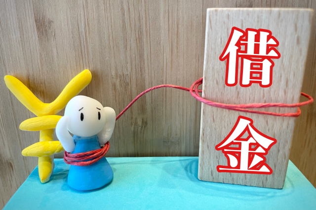 お金を手に頭を抱える。甲斐市で債務整理の無料相談ができます